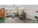 Bright living room with hardwood floors, a comfortable couch and two recliners at 1595 Cheatham Ford Rd, Hiddenite, NC 28636