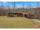Outbuilding for the property with a concrete driveway and green lawn at 1595 Cheatham Ford Rd, Hiddenite, NC 28636