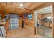 Room features wooden walls, wood floor, with a view to another room with tile floor at 1595 Cheatham Ford Rd, Hiddenite, NC 28636