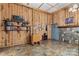 Inviting room features wood paneled walls, tile floor, and stone fireplace at 1595 Cheatham Ford Rd, Hiddenite, NC 28636