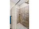Shower stall featuring neutral tile, a shower head, and a shower curtain at 1595 Cheatham Ford Rd, Hiddenite, NC 28636
