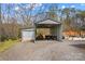 Open storage shed with various vehicles and equipment in the driveway at 1595 Cheatham Ford Rd, Hiddenite, NC 28636