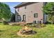 Backyard with deck, stone firepit with seating area, and lush green landscaping at 1650 Berkshire Dr, Hickory, NC 28602
