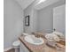 Comfortable bathroom featuring a granite-style counter and framed mirror at 1650 Berkshire Dr, Hickory, NC 28602