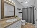 Well-lit bathroom featuring a shower with curtain, neutral walls, and white cabinets at 1650 Berkshire Dr, Hickory, NC 28602