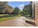 Wooden deck with railing overlooks a large, grassy backyard at 1650 Berkshire Dr, Hickory, NC 28602