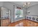 Bright dining room with hardwood floors, stylish buffet, and mirror at 1650 Berkshire Dr, Hickory, NC 28602