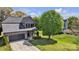 Aerial view of a two-story home with stone accents and a driveway leading to the garage in a grassy yard at 1650 Berkshire Dr, Hickory, NC 28602