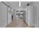 Long kitchen with stainless appliances, lots of cabinets and sliding barn door at 1650 Berkshire Dr, Hickory, NC 28602
