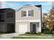 Charming two-story townhome showcasing a one-car garage, gray siding, and well-manicured landscaping at 1910 Old Rivers Rd, Concord, NC 28027