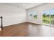 Open-concept living room features hardwood floors, stairwell, and access to the backyard through sliding glass doors at 1910 Old Rivers Rd, Concord, NC 28027