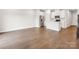Spacious living room with hardwood floors leading to a modern kitchen and open-concept living space at 1910 Old Rivers Rd, Concord, NC 28027