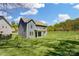 Spacious backyard featuring a lush lawn, mature trees, and a well-maintained exterior with a covered patio at 20422 Creek Bend Edge Ct, Matthews, NC 28105