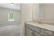 Bathroom vanity provides storage, along with a window in the adjacent carpeted room, offering natural light at 20422 Creek Bend Edge Ct, Matthews, NC 28105