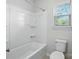 Bathroom features a bathtub-shower combo with a white surround and modern fixtures, offering a clean design at 20422 Creek Bend Edge Ct, Matthews, NC 28105