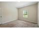 Bedroom with neutral carpet, a window providing natural light, and a crisp, clean interior at 20422 Creek Bend Edge Ct, Matthews, NC 28105