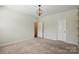 This is a bedroom with neutral carpet and lighting that features doorways to other rooms at 20422 Creek Bend Edge Ct, Matthews, NC 28105