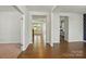 Open-concept entryway with gleaming hardwood floors, and easy access to the living room and kitchen at 20422 Creek Bend Edge Ct, Matthews, NC 28105