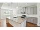 Modern kitchen boasts an island, granite countertops, stainless steel appliances, and ample cabinet space at 20422 Creek Bend Edge Ct, Matthews, NC 28105