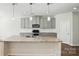 Bright kitchen featuring gray cabinets, a granite island, modern appliances, and an efficient layout at 20422 Creek Bend Edge Ct, Matthews, NC 28105