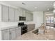 A kitchen featuring grey cabinets, stainless steel appliances, and granite countertops at 20422 Creek Bend Edge Ct, Matthews, NC 28105