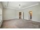 This main bedroom features a trey ceiling, neutral carpet, and doorways to other rooms at 20422 Creek Bend Edge Ct, Matthews, NC 28105