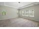 Spacious main bedroom featuring tray ceiling, recessed lights, and large windows at 20422 Creek Bend Edge Ct, Matthews, NC 28105