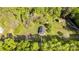 Aerial view of a home with lush trees, a long driveway, and a shed at 212 W Doc Garris Rd, Lancaster, SC 29720
