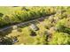 Aerial view shows house on a lot near a road and surrounded by lush greenery at 212 W Doc Garris Rd, Lancaster, SC 29720