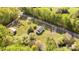 Aerial view shows house on a lot near a road and surrounded by lush greenery at 212 W Doc Garris Rd, Lancaster, SC 29720