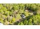 Aerial view of a home with lush trees, a long driveway, and a shed at 212 W Doc Garris Rd, Lancaster, SC 29720