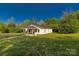 Charming cottage-style home with a covered porch, surrounded by a large, lush lawn and trees at 212 W Doc Garris Rd, Lancaster, SC 29720