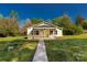 Inviting home features a covered front porch with seating, a walkway, and a well-manicured lawn at 212 W Doc Garris Rd, Lancaster, SC 29720