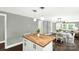 Open floor plan kitchen with butcher block island, dining area and living area with natural light at 212 W Doc Garris Rd, Lancaster, SC 29720