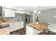 Bright kitchen showcasing butcher block island and butcher block countertops with white cabinets at 212 W Doc Garris Rd, Lancaster, SC 29720