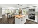 Open floor plan showcasing a kitchen with white cabinetry and a center island with dining area and living area at 212 W Doc Garris Rd, Lancaster, SC 29720
