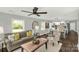 Comfortable living room with lots of natural light, neutral tones, ceiling fan, and open-concept layout at 212 W Doc Garris Rd, Lancaster, SC 29720