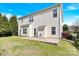 Large, grassy backyard featuring a concrete patio, partial fence and ample room for outdoor activities at 2275 Laurens Dr, Concord, NC 28027