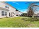 View of a grassy backyard featuring a patio area, fencing, and well-kept lawn at 2275 Laurens Dr, Concord, NC 28027