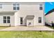 Rear view of a home with a concrete patio and grassy backyard at 2275 Laurens Dr, Concord, NC 28027