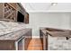 Sophisticated bar area with custom cabinets, a wine fridge and hardwood flooring at 2275 Laurens Dr, Concord, NC 28027