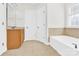Bright bathroom with a vanity sink, tiled floors and bathtub with ceramic tile surround at 2275 Laurens Dr, Concord, NC 28027