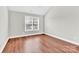 Bright bedroom featuring hardwood floors and a large window at 2275 Laurens Dr, Concord, NC 28027