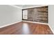 Serene bedroom retreat with wood-look accent wall and hardwood floors at 2275 Laurens Dr, Concord, NC 28027