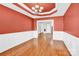 Elegant dining room with hardwood floors, tray ceiling, and stylish chandelier, perfect for entertaining guests at 2275 Laurens Dr, Concord, NC 28027