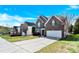 Beautiful two-story brick home with a manicured lawn, two car garage and inviting curb appeal at 2275 Laurens Dr, Concord, NC 28027