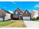 Charming two-story brick home with a two-car garage and well-maintained landscaping at 2275 Laurens Dr, Concord, NC 28027
