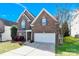 Charming two-story brick home with a two-car garage and well-maintained landscaping at 2275 Laurens Dr, Concord, NC 28027