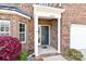 Charming front entrance with brick facade, decorative columns, and manicured landscaping at 2275 Laurens Dr, Concord, NC 28027