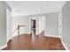 Well-lit hallway boasts hardwood floors and neutral walls at 2275 Laurens Dr, Concord, NC 28027